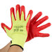 A pair of yellow and red Cordova heavy duty work gloves with a red foam nitrile palm coating.