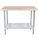 An Advance Tabco wood top work table with a galvanized metal base and undershelf.