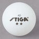 A pack of 6 Stiga white ping pong balls with black text.