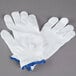 A pair of white Cordova jersey gloves with blue trim.