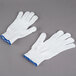 A pair of white Cordova work gloves with blue trim.