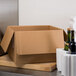 A Polar Tech cardboard box with bottles of wine on a counter.