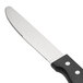 A Walco stainless steel steak knife with a black plastic handle.
