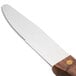 A Walco stainless steel steak knife with a stained hardwood handle.