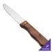 A Walco stainless steel steak knife with a stained hardwood handle.