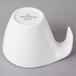 A white ceramic tea cup with a handle.
