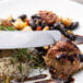 A plate of food with meatballs, black beans, and rice with a Walco Lancer stainless steel dinner knife.
