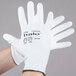 A person wearing Cordova white gloves with white polyurethane palm coating.