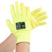 A pair of Cordova yellow cut resistant gloves with a yellow polyurethane palm coating.