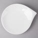 A white Villeroy & Boch porcelain flat plate on a gray surface.