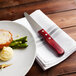 A plate of food with a Walco steak knife and napkin on it.