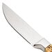 A Walco stainless steel steak knife with a wooden handle.