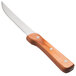 A Walco stainless steel steak knife with a brown Pakka wood handle.