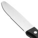 A Walco stainless steel steak knife with a black Delrin handle.