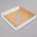 A white rectangular Lavex cardboard lid with a hole in the middle.