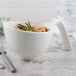 A white Villeroy & Boch porcelain handled bowl with a bowl of noodles and a sprig of rosemary.