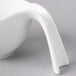 A white Villeroy & Boch porcelain bowl with a long curved handle.