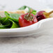 A Villeroy & Boch white porcelain plate with spinach, peppers, and tomatoes.