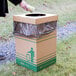 A hand putting a Lavex Kraft cardboard lid on a trash can.