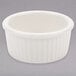 A white ceramic Tuxton fluted ramekin with a ribbed rim.