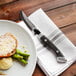 A plate of food with a Walco Boston Chop steak knife.