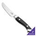 A Walco stainless steel steak knife with a black Delrin handle.