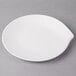 A Villeroy & Boch white porcelain flat plate with a curved edge.