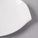 A Villeroy & Boch Flow white porcelain flat plate with a white rim on a gray surface.