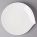 A white Villeroy & Boch porcelain flat plate on a gray surface.