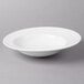 A white Villeroy & Boch porcelain pasta plate on a gray surface.