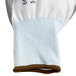 A close up of a pair of white Cordova Caliber gloves with a gray palm coating.