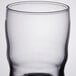 A clear Libbey beverage glass with a black rim.