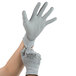 A pair of hands wearing extra large Cordova gray gloves with a polyurethane palm.