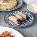 A close-up of food on an Arcoroc Candour Azure porcelain plate.