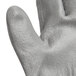 A close up of a pair of Cordova Caliber gray gloves with a gray palm.
