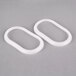 Two white oval shaped gaskets for a Crathco beverage dispenser bowl.
