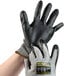 A pair of Cordova Monarch gray and black heavy duty work gloves on a hand.