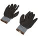 A pair of Cordova black and gray grip gloves with black latex crinkle palm coating.