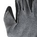 A close up of a pair of Cordova gray gloves with black latex crinkle coating on the palm and finger tips.