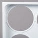 A white plastic tray with four circles.