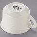 A Tuxton eggshell white china cup with an embossed rim.