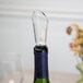 A wine bottle with a Franmara air-flow wine pourer and aerator on top.