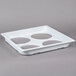 A white tray with four circles.