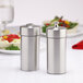 Two salt and pepper shakers on a table.