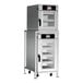 A stacked electric oven package with two stainless steel multi-cook ovens, each featuring a digital control panel and multiple interior shelves.