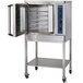 A stainless steel Alto-Shaam oven stand with open front and back doors.