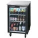 A Beverage-Air black back bar refrigerator full of beer bottles on shelves.