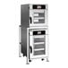 A stacked electric oven package with two separate cooking chambers, each featuring a glass door and digital control panel, designed for commercial kitchen use.