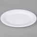 A white oval melamine platter with a white rim.