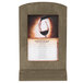 A Menu Solutions weathered walnut wood menu tent frame with a picture of a glass of wine on a table.